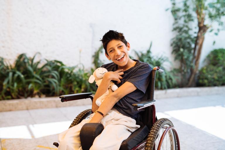 boy in wheelchair laughing