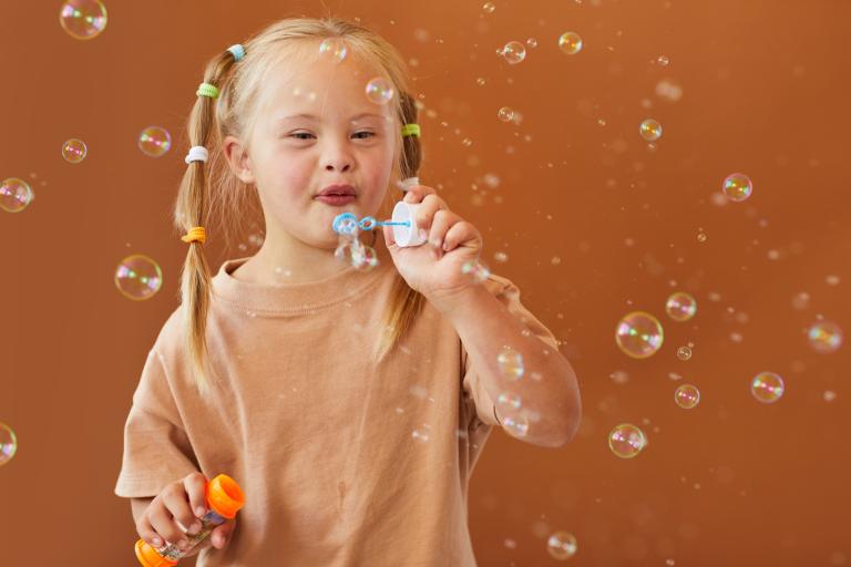 girl blowing bubbles