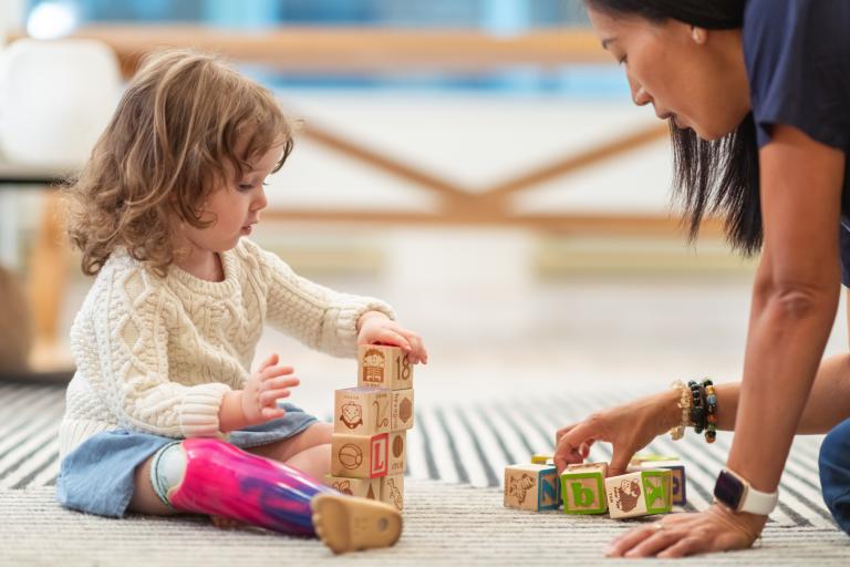 adult and child playing on the floor 