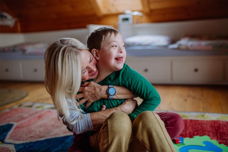 adult hugging child smiling 