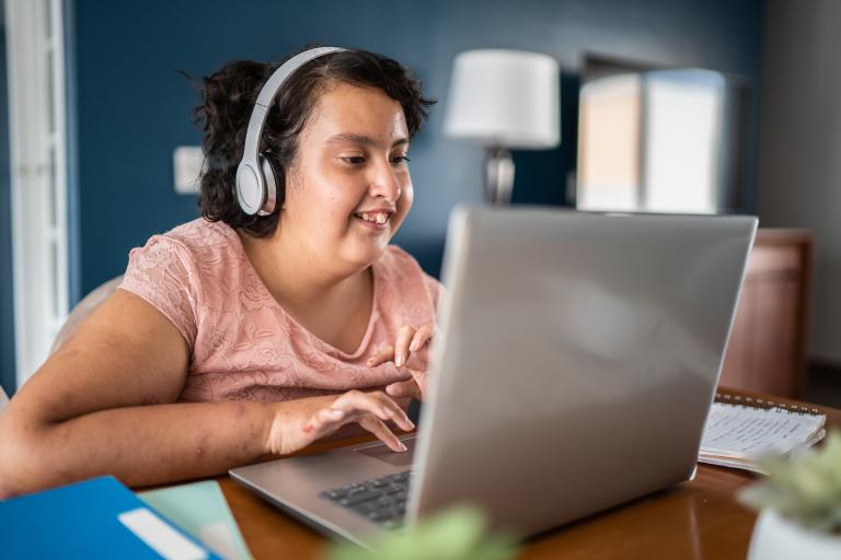 female young person on laptop