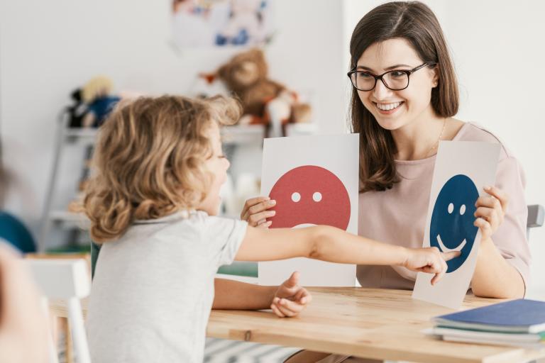 child and adult at a desk