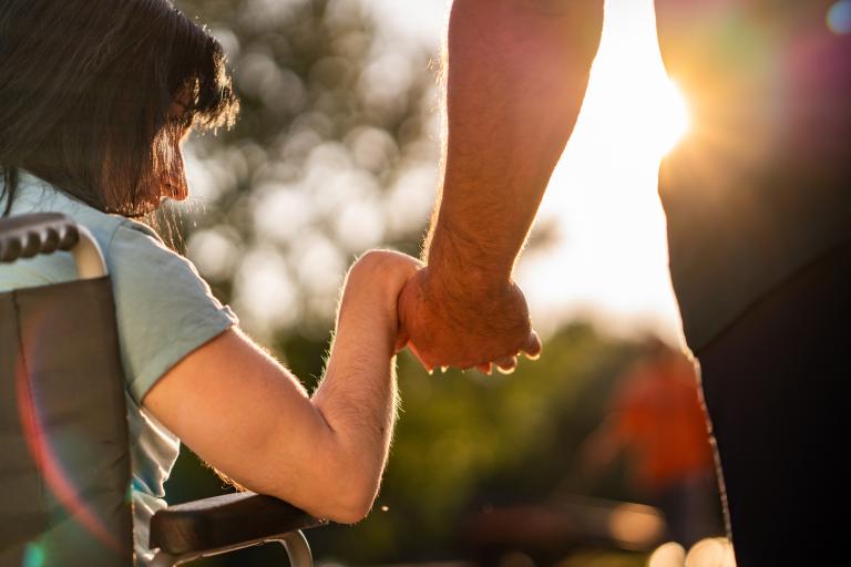 young person holding hands with adult