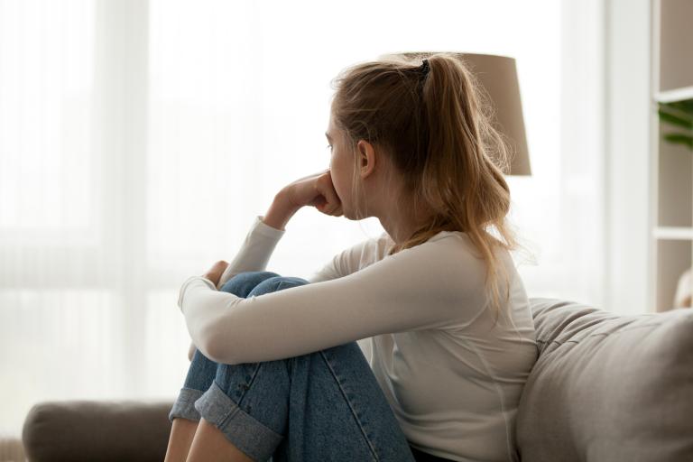 young person sitting on sofa