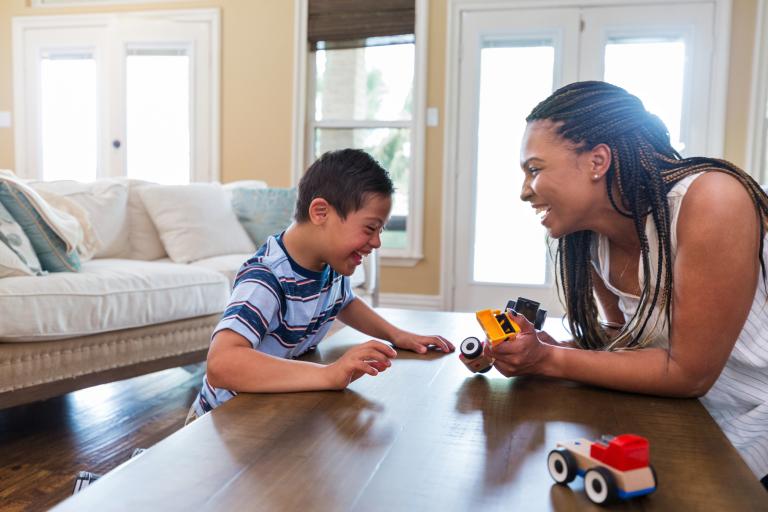 child and adult playing