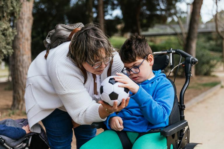 boy in wheelchair with football