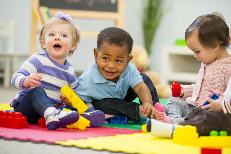 three young children playing in setting 