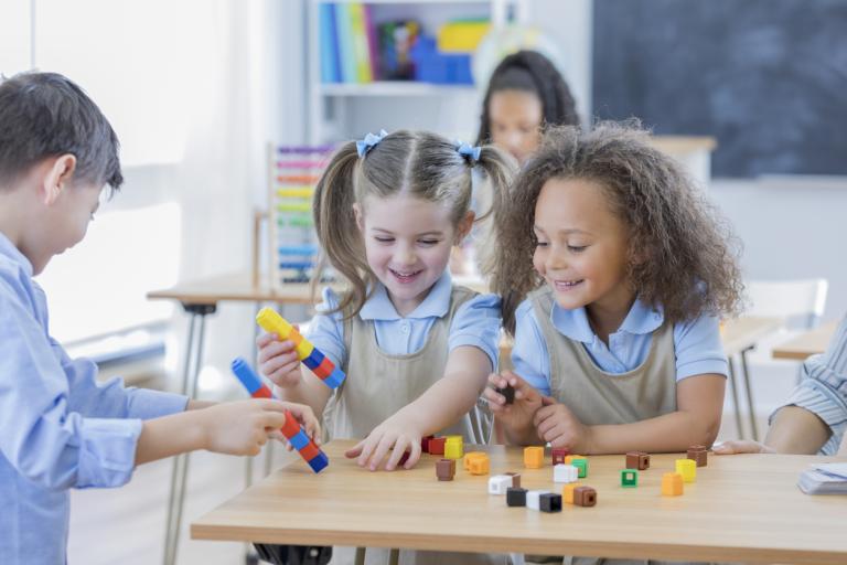 students play with counting cubes at school